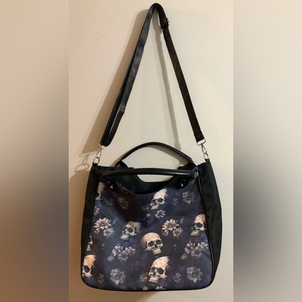 Black crossbody bag with skulls.